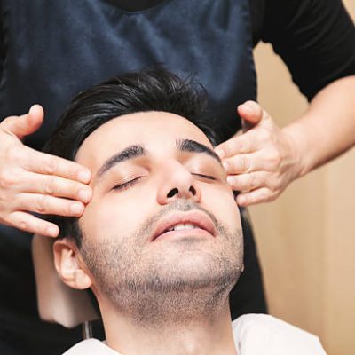 Young Turkish man getting skin care and facial massage - male beauty